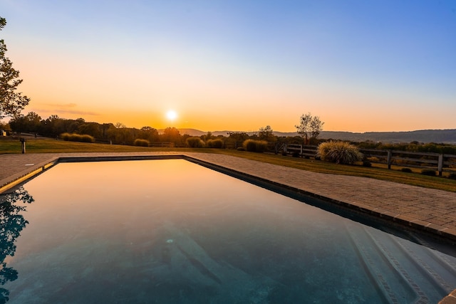 view of pool at dusk