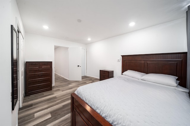 bedroom with dark hardwood / wood-style floors