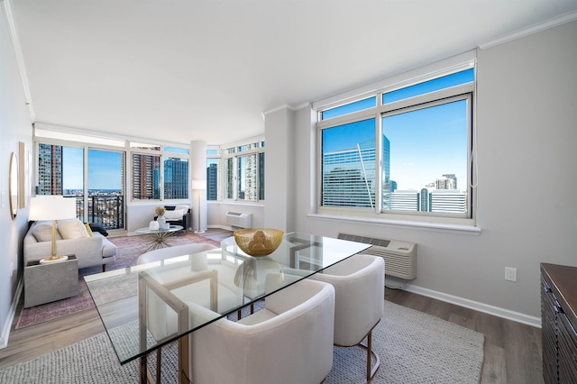 20 2nd St Unit 2503, Jersey City, NJ 07302 - dining room with wood finished floors, plenty of natural light, a wall unit AC, and crown molding
