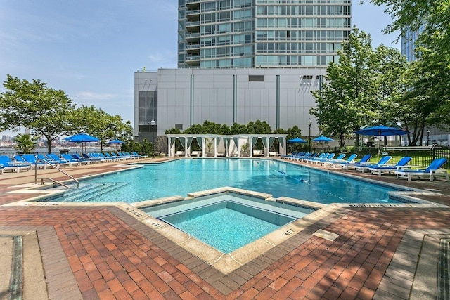 20 2nd St Unit 2503, Jersey City, NJ 07302 - view of pool featuring a pool with connected hot tub and a patio area