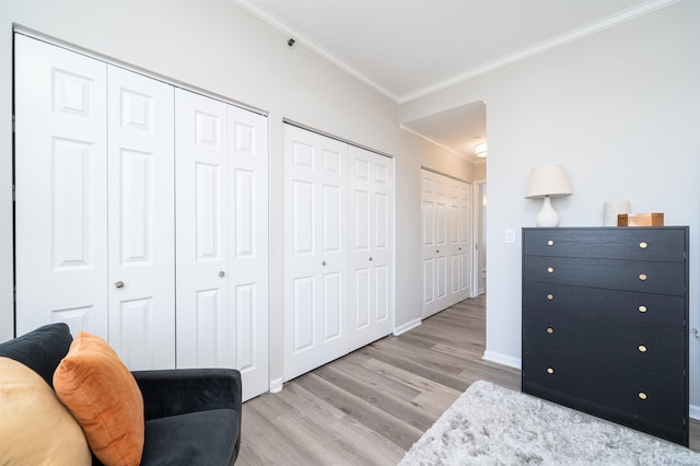 20 2nd St Unit 2503, Jersey City, NJ 07302 - bedroom with ornamental molding, wood finished floors, multiple closets, and baseboards