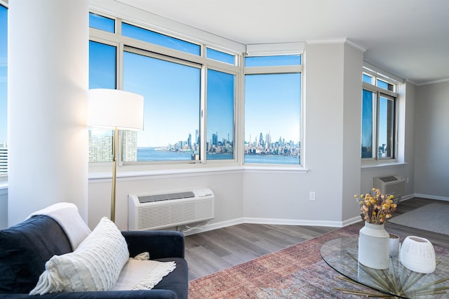 20 2nd St Unit 2503, Jersey City, NJ 07302 - living room featuring a wall mounted air conditioner, wood finished floors, baseboards, and crown molding