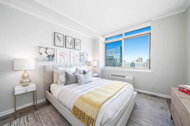 20 2nd St Unit 2503, Jersey City, NJ 07302 - bedroom with wood finished floors, baseboards, crown molding, and a wall unit AC