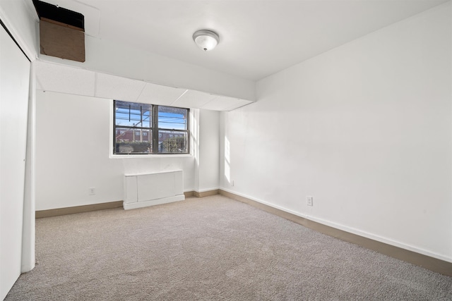 carpeted empty room with baseboards