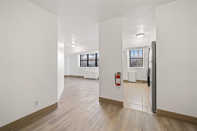 empty room featuring light wood-style floors and baseboards