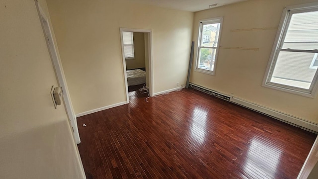 unfurnished bedroom featuring a baseboard radiator and dark hardwood / wood-style flooring