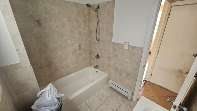 bathroom with tiled shower / bath combo, tile walls, tile patterned floors, and a baseboard heating unit