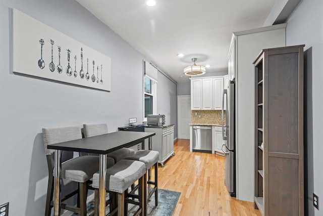 403 Monroe St Unit 3L, Hoboken, NJ 07030 - kitchen featuring appliances with stainless steel finishes, backsplash, recessed lighting, light wood finished floors, and white cabinets