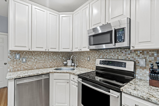 403 Monroe St Unit 3L, Hoboken, NJ 07030 - kitchen featuring appliances with stainless steel finishes, a sink, white cabinets, and tasteful backsplash
