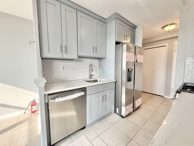 1225 Kennedy Blvd Unit 5E, Bayonne, NJ 07002 - kitchen with gray cabinets, appliances with stainless steel finishes, a sink, and decorative backsplash