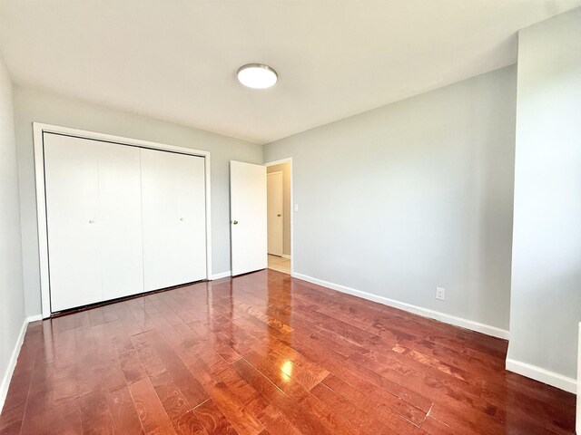 1225 Kennedy Blvd Unit 5E, Bayonne, NJ 07002 - unfurnished bedroom featuring wood finished floors, baseboards, and a closet