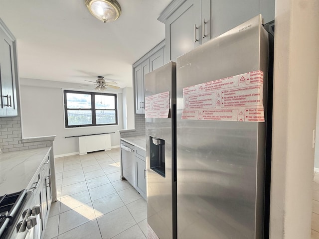 1225 Kennedy Blvd Unit 5E, Bayonne, NJ 07002 - kitchen with appliances with stainless steel finishes, gray cabinets, a ceiling fan, decorative backsplash, and light stone countertops