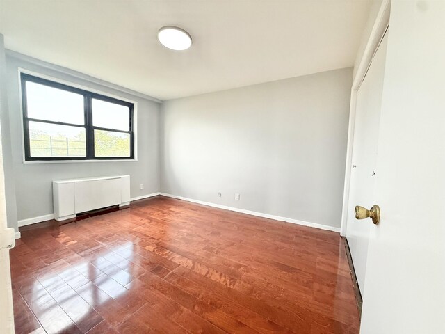 1225 Kennedy Blvd Unit 5E, Bayonne, NJ 07002 - unfurnished room with radiator, wood finished floors, and baseboards