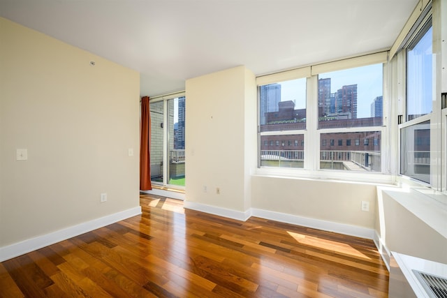 88 Morgan St Unit 802, Jersey City, NJ 07302 - spare room featuring hardwood / wood-style flooring and a skyline view