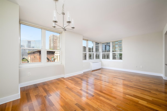 88 Morgan St Unit 802, Jersey City, NJ 07302 - empty room with a chandelier, plenty of natural light, and light wood finished floors