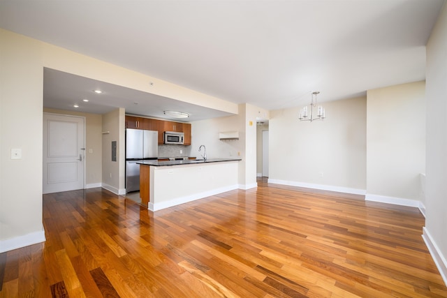88 Morgan St Unit 802, Jersey City, NJ 07302 - unfurnished living room with a chandelier, wood finished floors, and recessed lighting