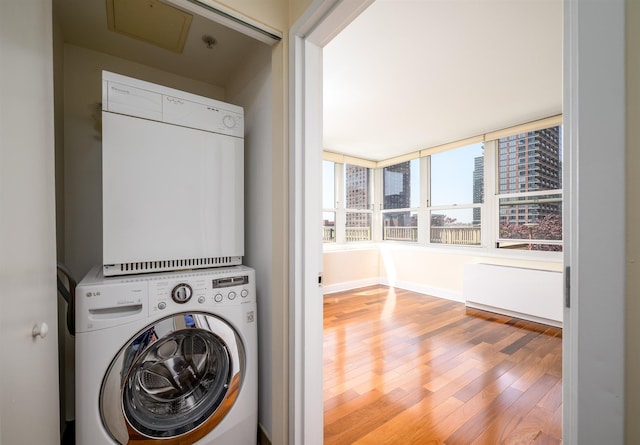 88 Morgan St Unit 802, Jersey City, NJ 07302 - laundry area with stacked washer / drying machine, wood finished floors, and a view of city