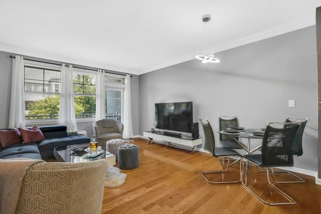 living room with wood-type flooring and crown molding