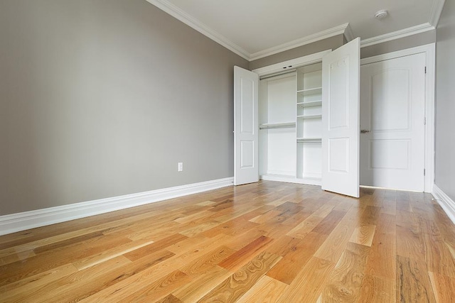 385 1st St, Jersey City, NJ 07302 - unfurnished bedroom featuring ornamental molding, light wood-style flooring, baseboards, and a closet