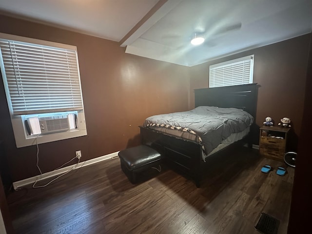 bedroom with ceiling fan, dark hardwood / wood-style floors, and cooling unit