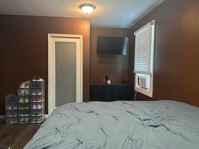 bedroom featuring cooling unit and dark hardwood / wood-style floors