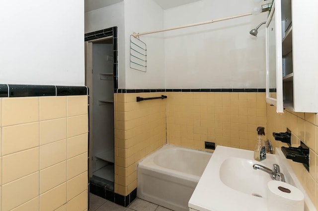 bathroom featuring sink, tile walls, tile patterned floors, and plus walk in shower