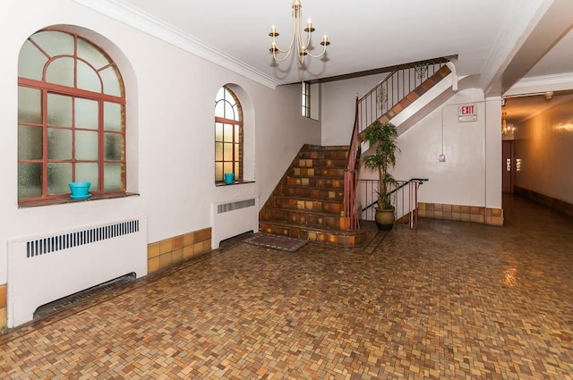 interior space featuring radiator heating unit, ornamental molding, and a chandelier