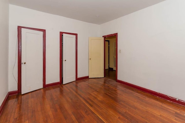 unfurnished bedroom with dark hardwood / wood-style flooring