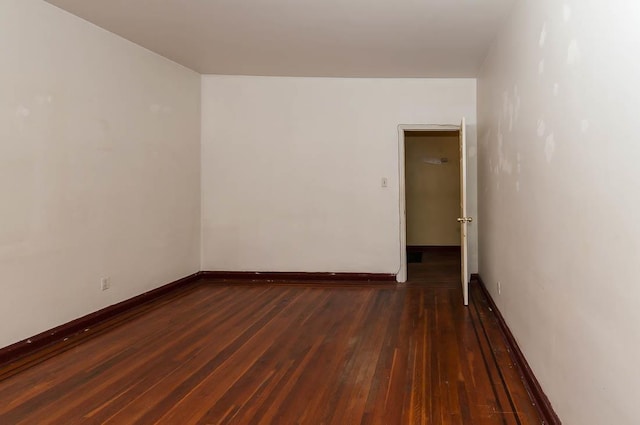 empty room featuring dark wood-type flooring