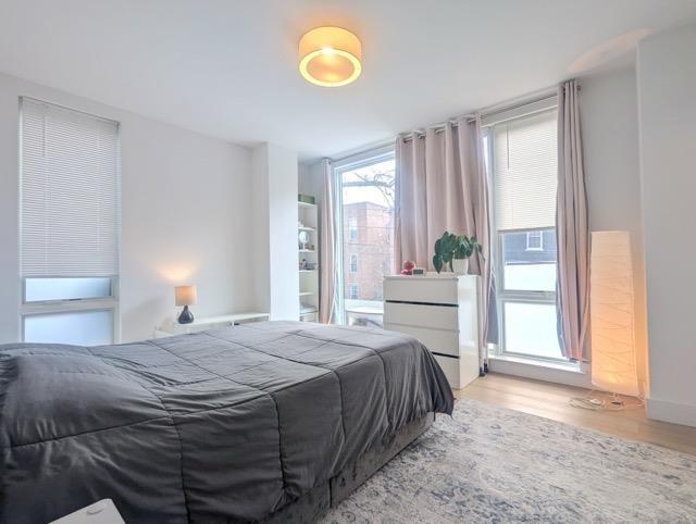 bedroom with light wood-style flooring and baseboards