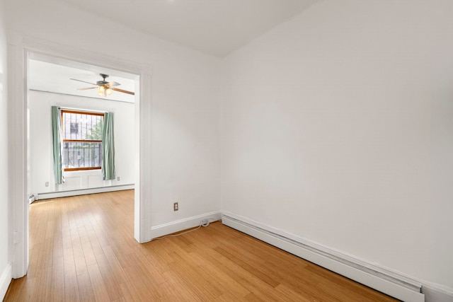 50 Bright Street 1L Or 101, Jersey City, NJ 07302 - unfurnished room with a baseboard heating unit, baseboard heating, light wood-style floors, baseboards, and ceiling fan