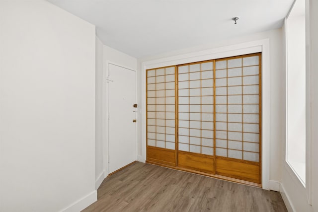 227 Bay St Unit 4B, Jersey City, NJ 07302 - empty room featuring light wood-style floors and fire sprinkler in ceiling