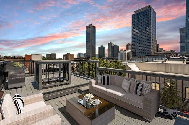 227 Bay St Unit 4B, Jersey City, NJ 07302 - deck at dusk with an outdoor living space, a skyline view, and a grill