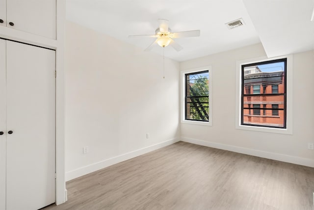 227 Bay St Unit 4B, Jersey City, NJ 07302 - unfurnished bedroom featuring light wood finished floors, a closet, and a ceiling fan