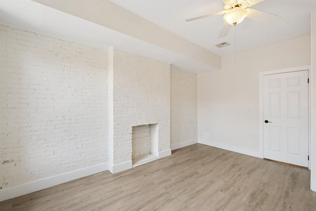 227 Bay St Unit 4B, Jersey City, NJ 07302 - empty room with brick wall, light wood-type flooring, and ceiling fan