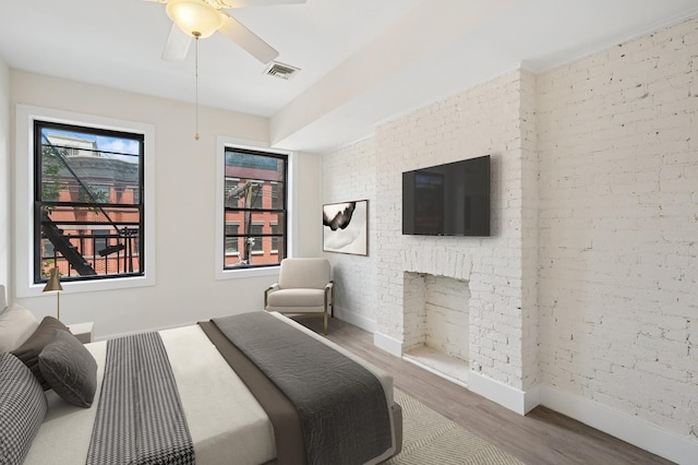 227 Bay St Unit 4B, Jersey City, NJ 07302 - bedroom featuring wood finished floors, brick wall, and ceiling fan