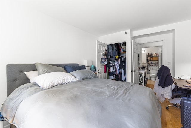 bedroom with a closet and wood finished floors