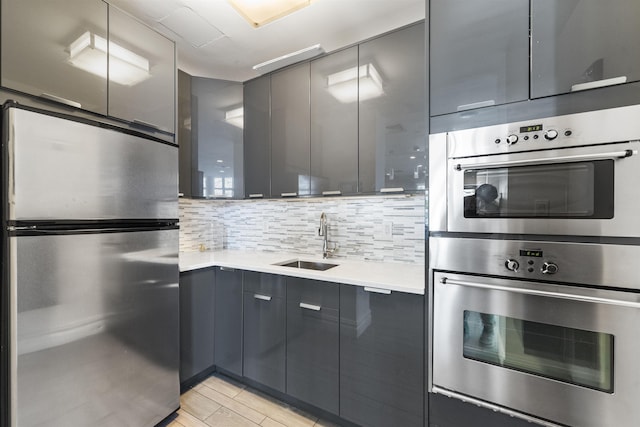 kitchen featuring a sink, appliances with stainless steel finishes, modern cabinets, and gray cabinetry