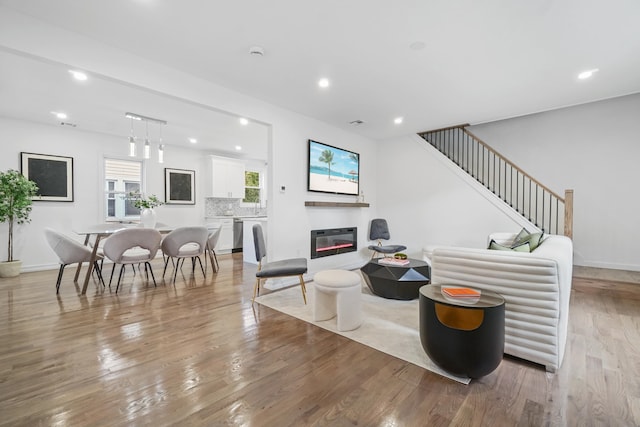 living room featuring heating unit and light wood-type flooring