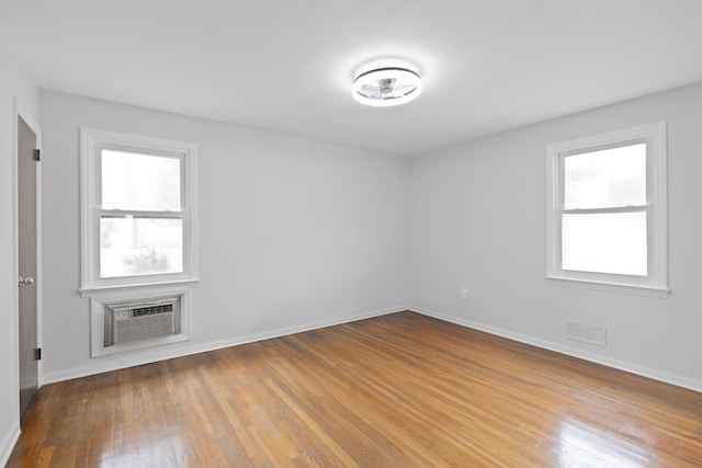 64 W 57th St, Bayonne, NJ 07002 - empty room featuring hardwood / wood-style flooring and a wall mounted air conditioner