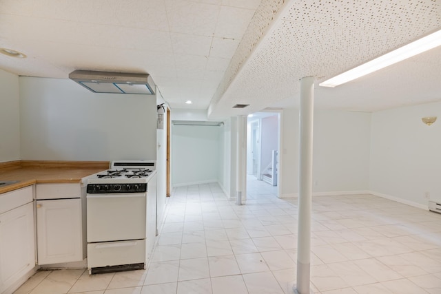 64 W 57th St, Bayonne, NJ 07002 - kitchen featuring white gas range, ventilation hood, white cabinets, and light countertops