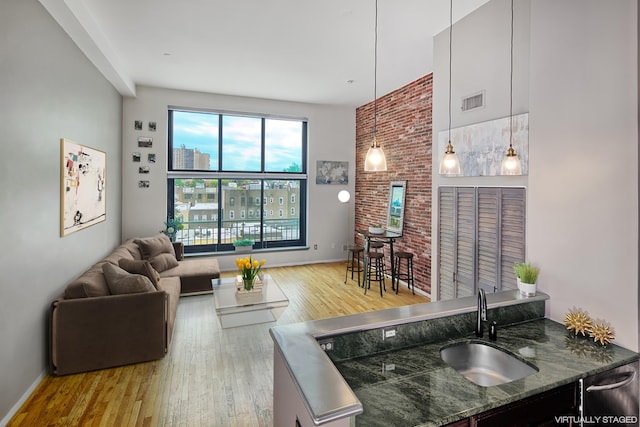living room featuring baseboards, wood finished floors, and visible vents