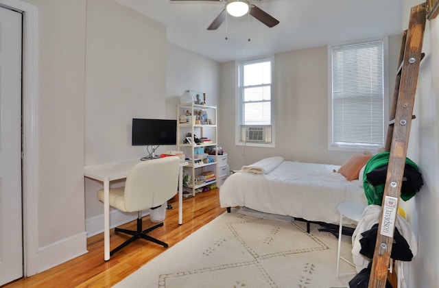 bedroom with ceiling fan and hardwood / wood-style floors