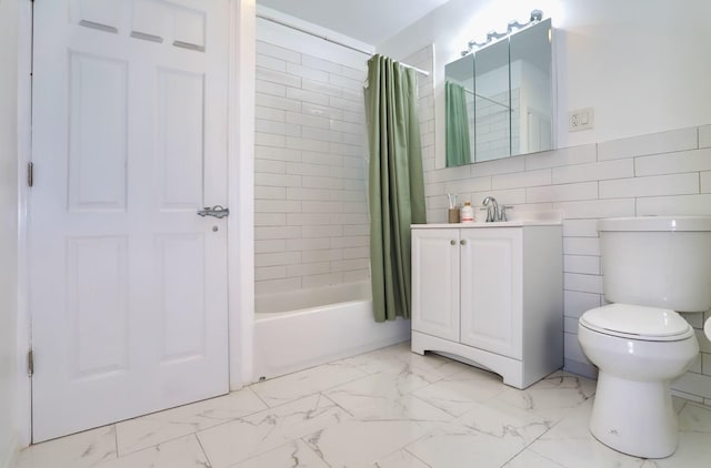 full bathroom with shower / tub combo with curtain, vanity, tile walls, and toilet