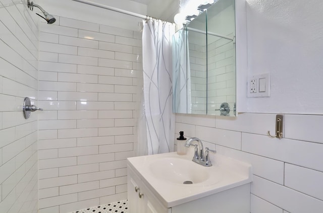 bathroom featuring decorative backsplash, vanity, curtained shower, and tile walls