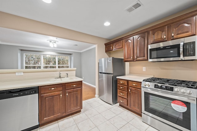 4 Boatworks Dr, Bayonne, NJ 07002 - kitchen featuring stainless steel appliances, a sink, crown molding, light countertops, and light tile patterned flooring