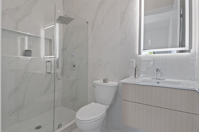 bathroom with toilet, a shower with door, vanity, and tile walls