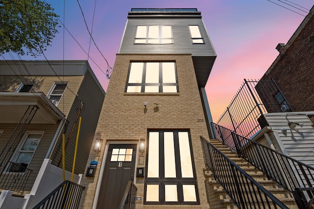 view of back house at dusk