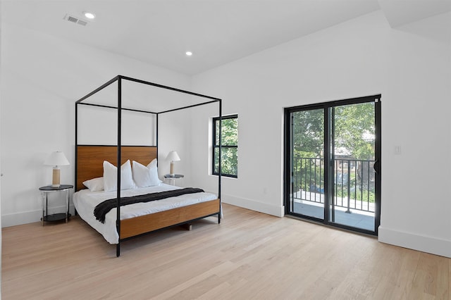 bedroom with light wood-type flooring and access to outside