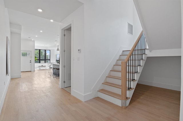 staircase with hardwood / wood-style flooring